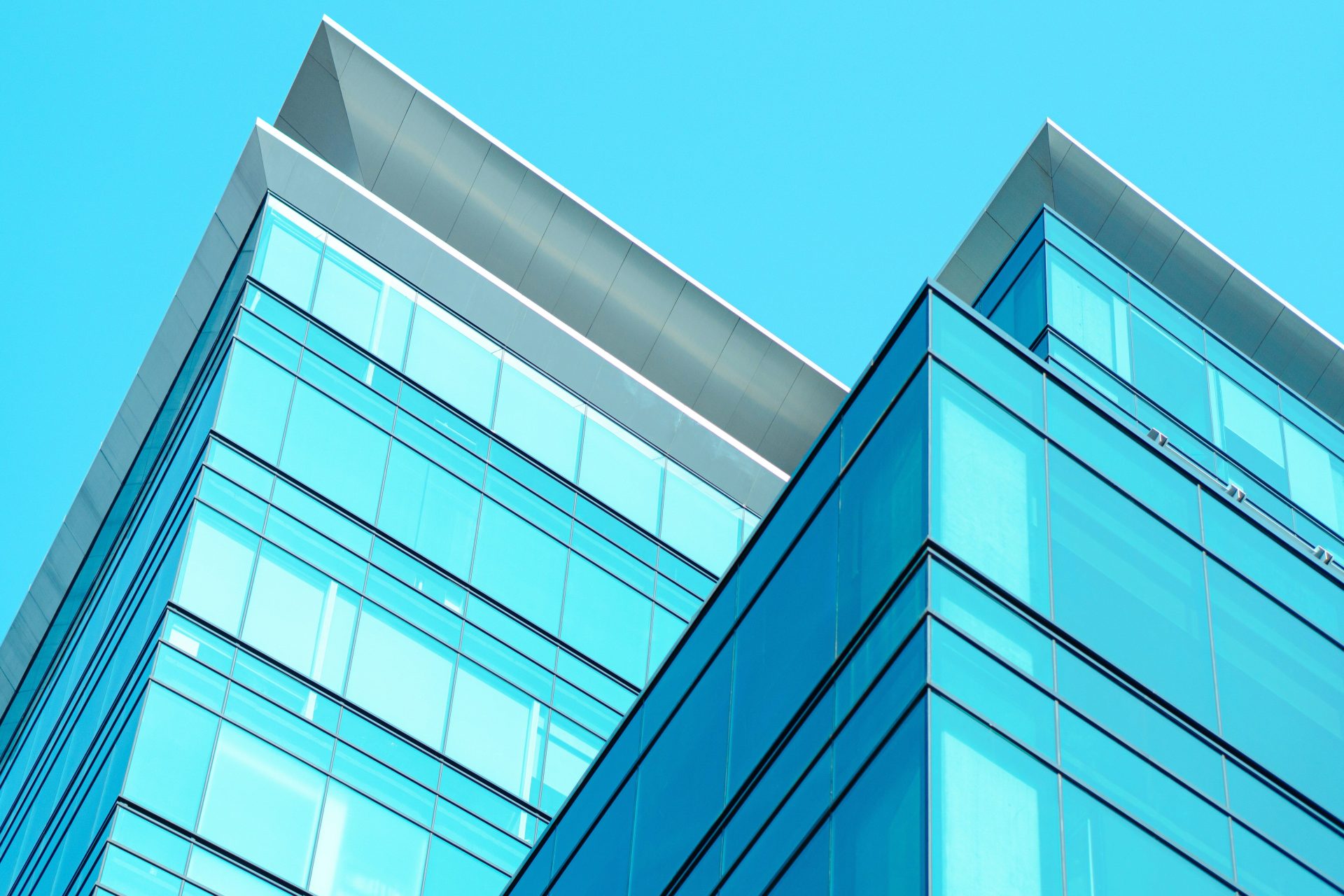 a close up of two tall buildings against a blue sky