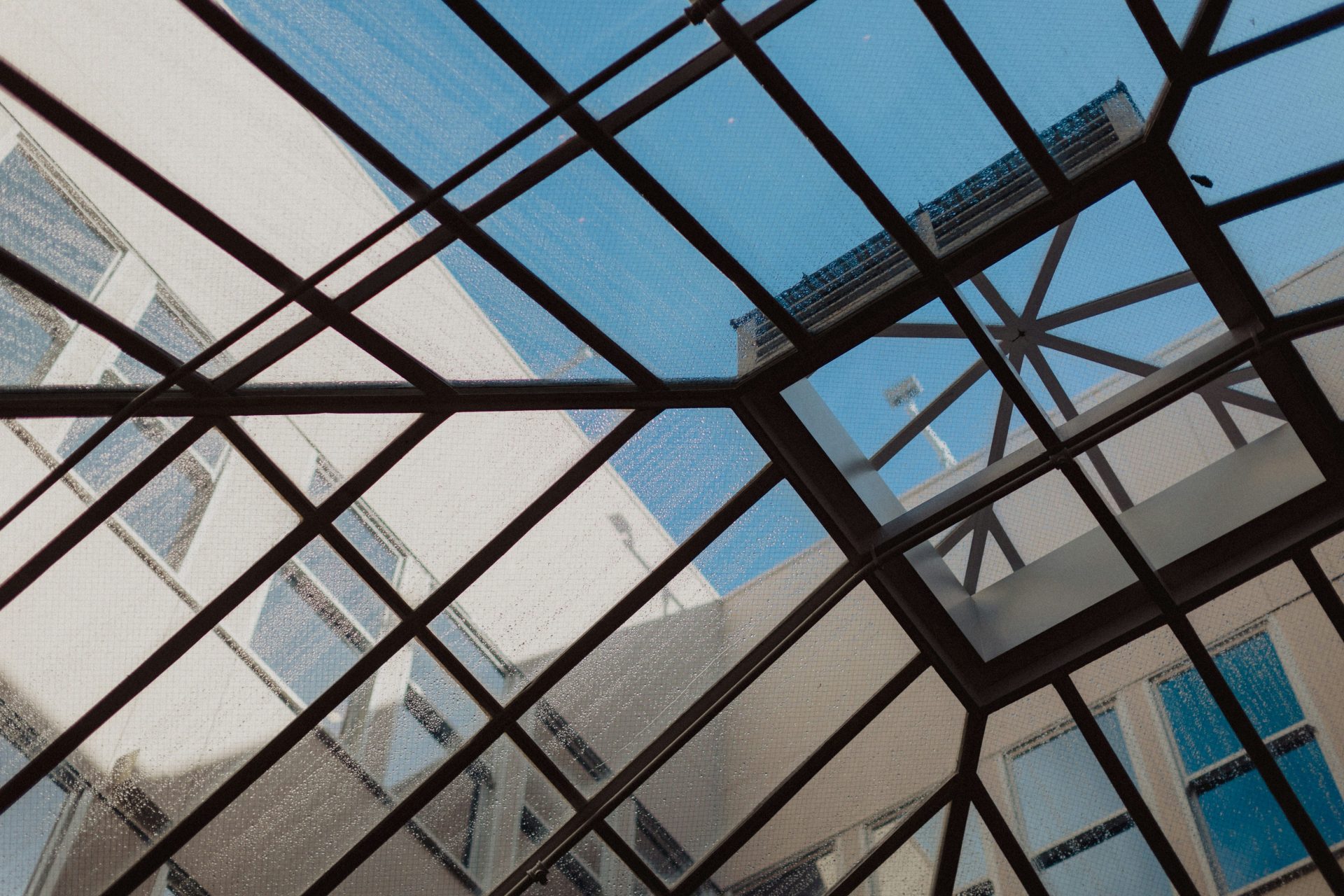 a view of a building through a glass roof