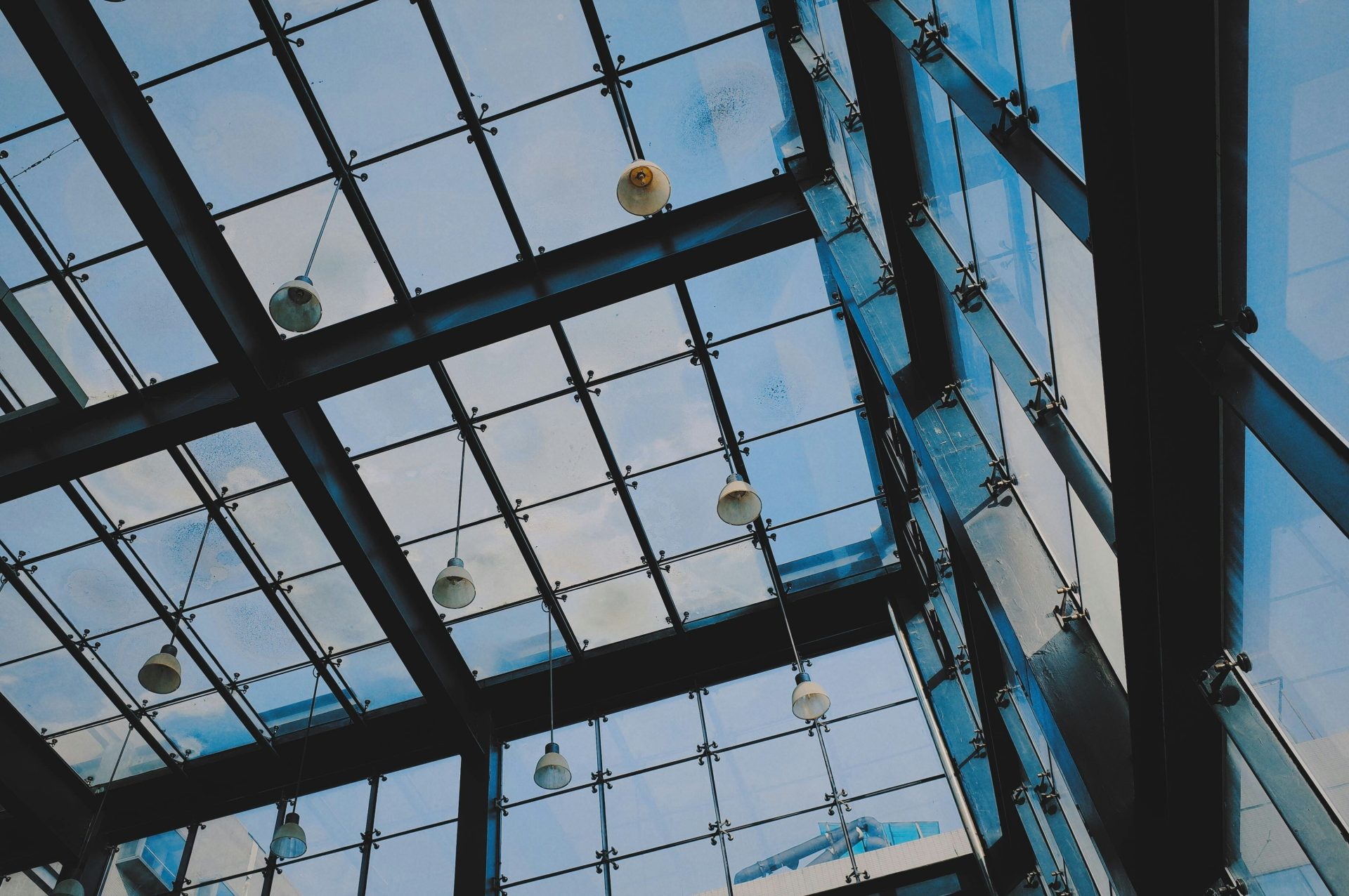 low angle photo of pendant lamp inside glassy building